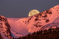 Moonset at Sunrise - Peaks on the Western Horizon Bathed in Alpenglow as Full Moon Sets